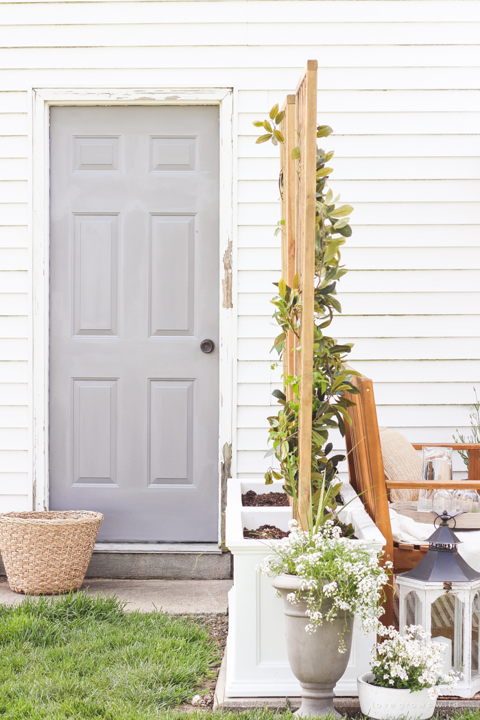 A boring, bare patio turned into a gorgeous outdoor entertaining area! See the incredible before and after of this beautiful patio makeover! 