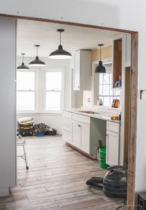 Follow along the makeover of this beautiful farmhouse kitchen! In this post, Liz shares all the finishing touches she picked for lighting, faucets, furniture, and more!