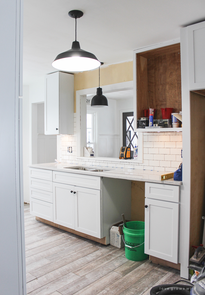 Follow along the makeover of this beautiful farmhouse kitchen! In this post, Liz shares all the finishing touches she picked for lighting, faucets, furniture, and more!