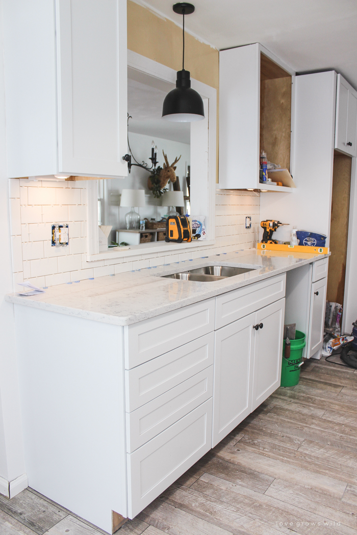 Follow along the makeover of this beautiful farmhouse kitchen! In this post, Liz shares all the finishing touches she picked for lighting, faucets, furniture, and more!