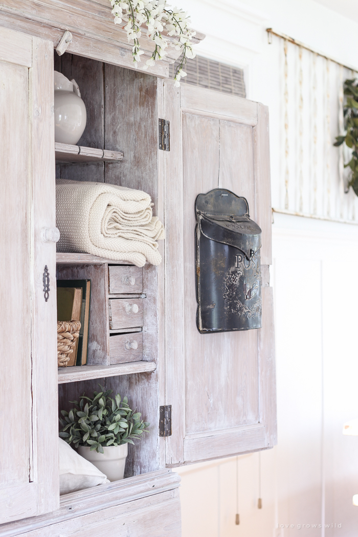 Step inside this beautiful Indiana farmhouse entryway decorated with a mix of timeworn antiques and unique DIY projects!