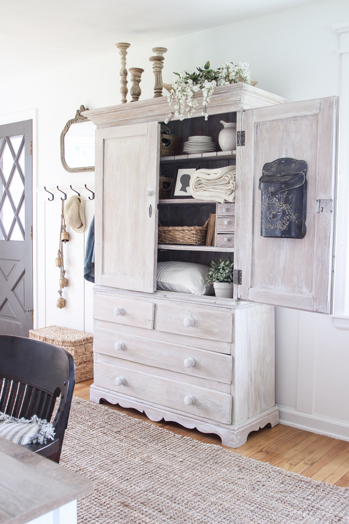 Step inside this beautiful Indiana farmhouse entryway decorated with a mix of timeworn antiques and unique DIY projects!