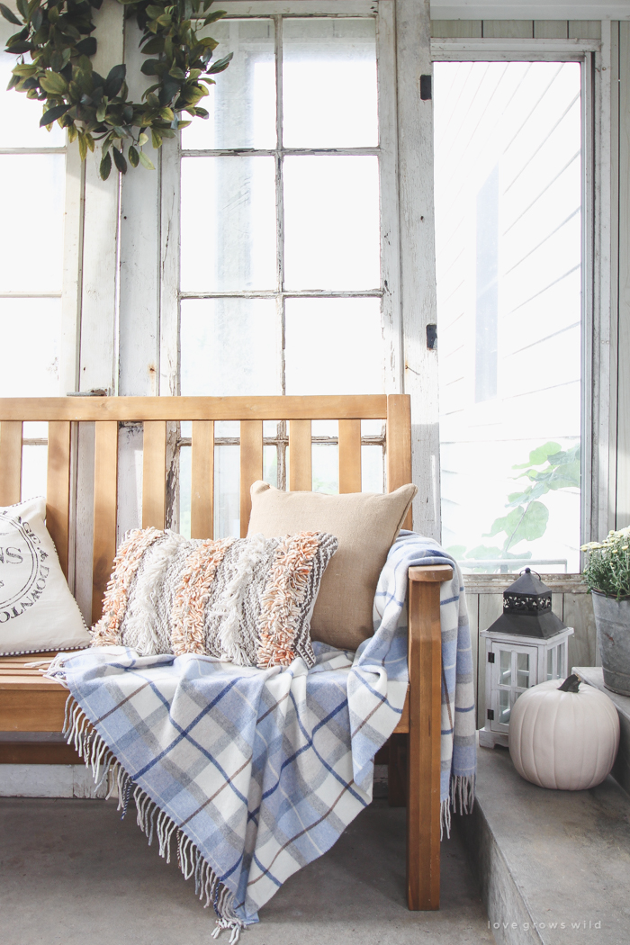 A beautiful farmhouse front porch decorated with simple touches of fall!