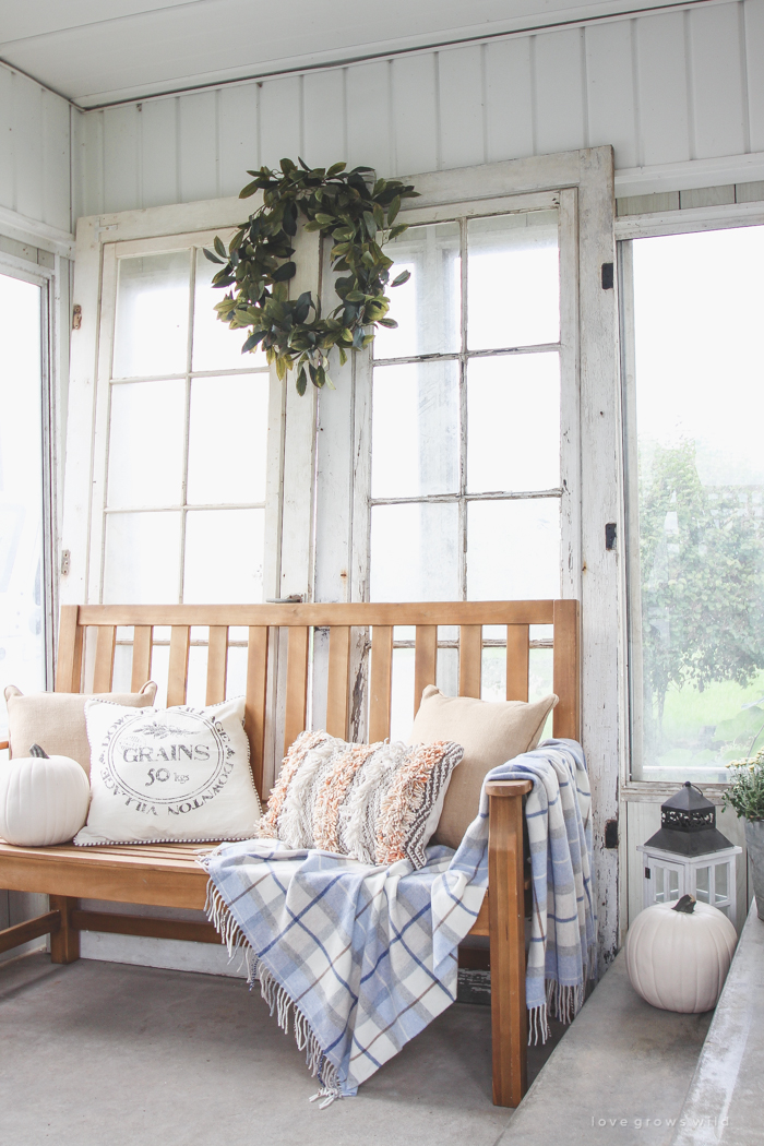 A beautiful farmhouse front porch decorated with simple touches of fall!