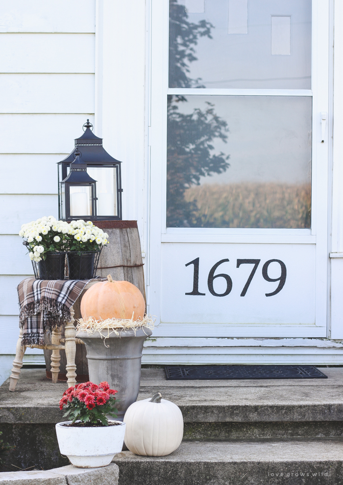 A beautiful farmhouse front porch decorated with simple touches of fall!