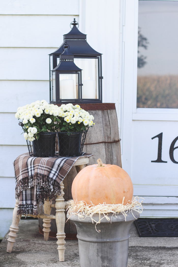 A beautiful farmhouse front porch decorated with simple touches of fall!