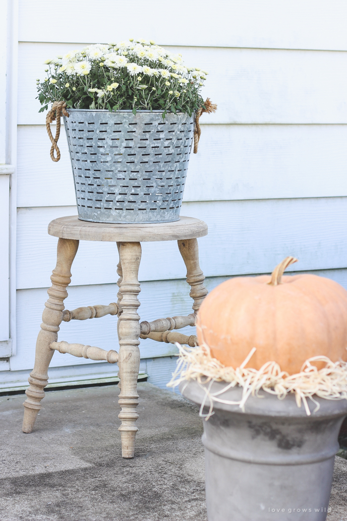 A beautiful farmhouse front porch decorated with simple touches of fall!
