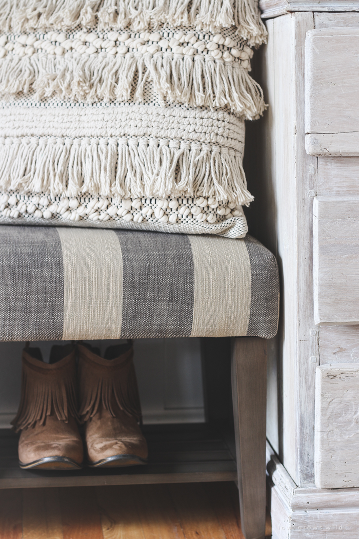 This beautiful farmhouse entryway is the perfect mix of style and organization with a cozy bench, hooks for coat storage, and a basket for accessories. 