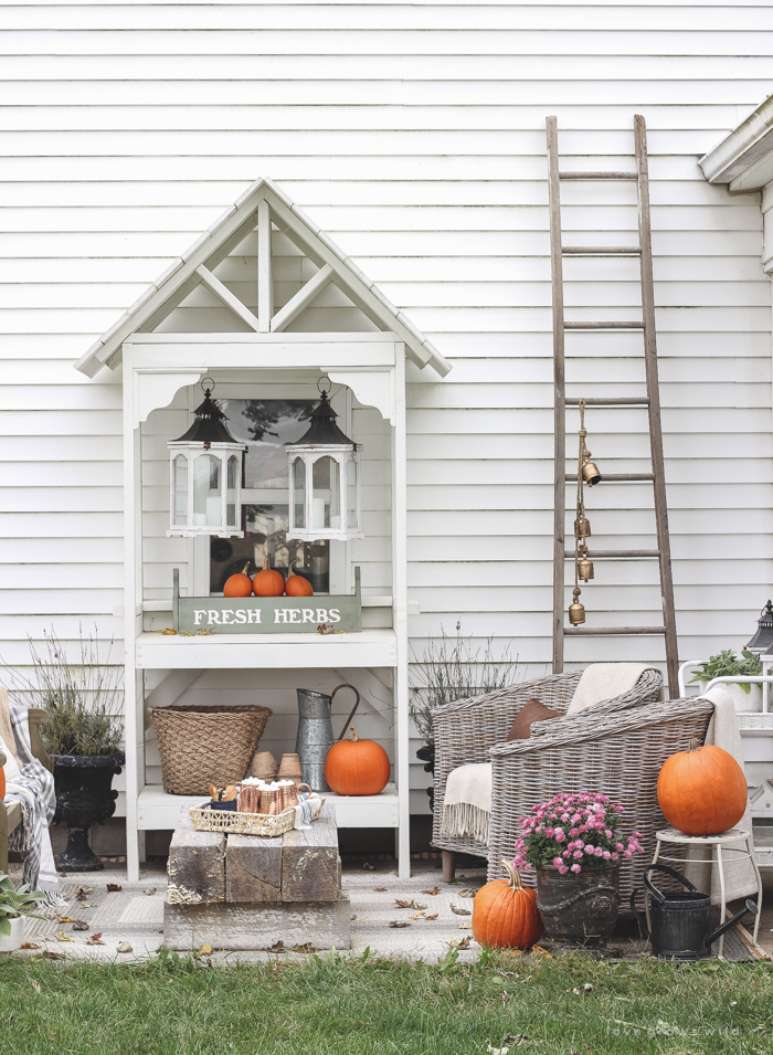 A small patio is transformed into a cozy seating area for fall. 