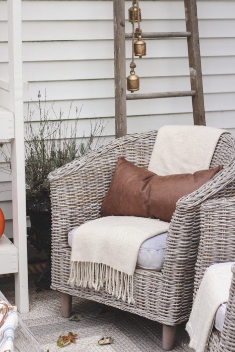 A small patio is transformed into a cozy seating area for fall.