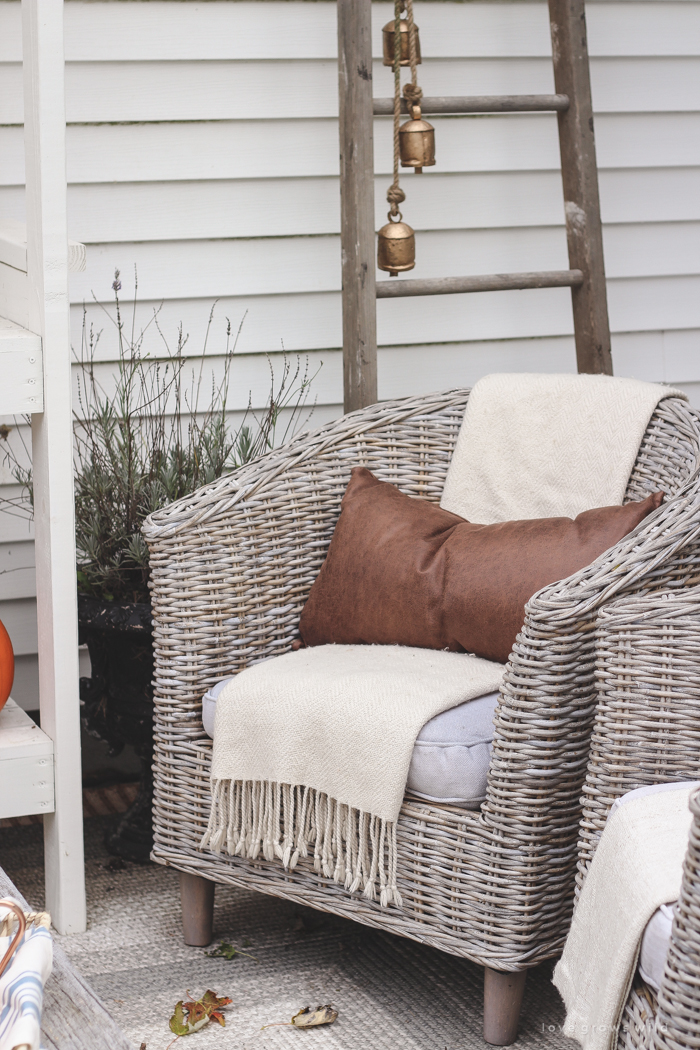 A small patio is transformed into a cozy seating area for fall. 