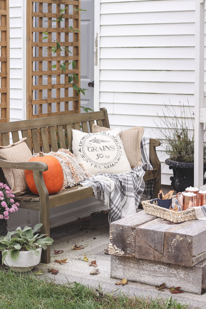 A small patio is transformed into a cozy seating area for fall. 