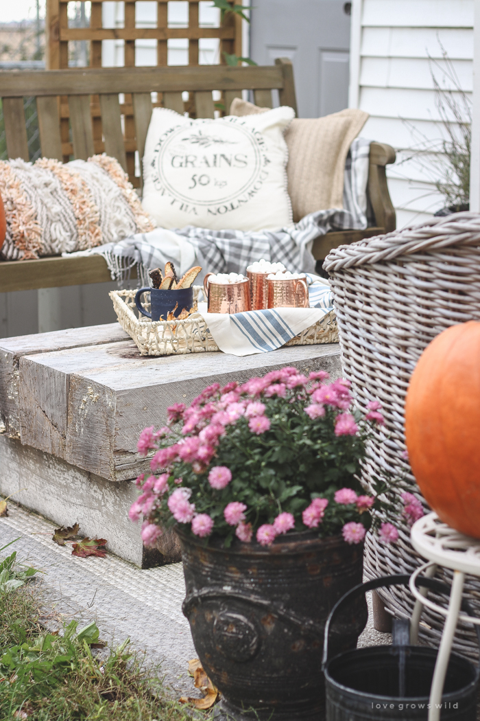 A small patio is transformed into a cozy seating area for fall. 