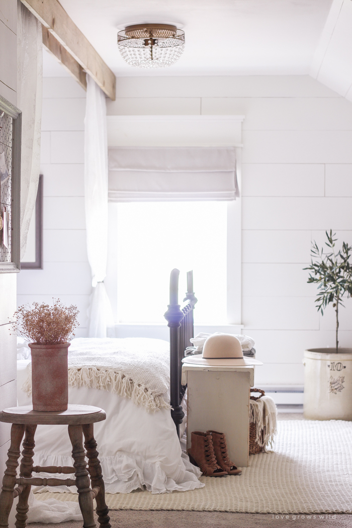 A clean and cozy farmhouse master bedroom with tons of vintage charm