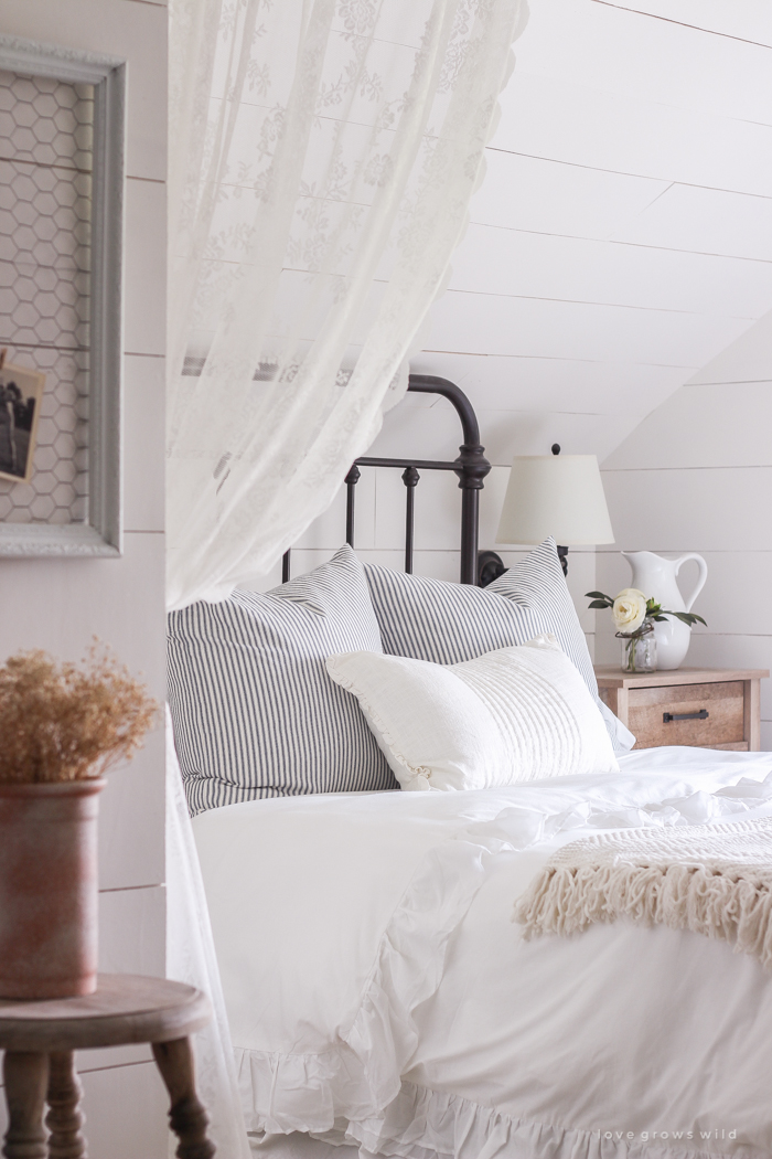 A clean and cozy farmhouse master bedroom with tons of vintage charm