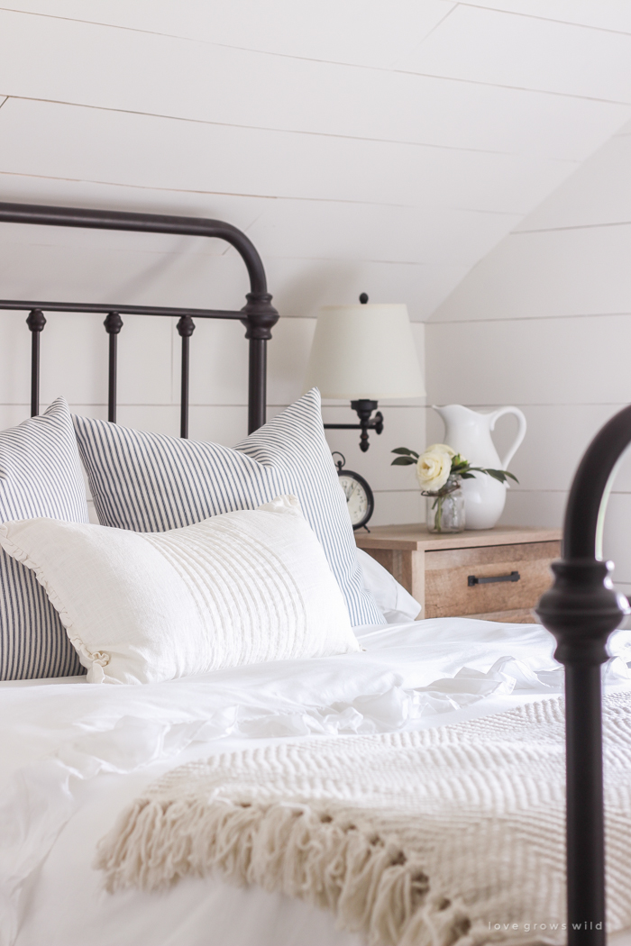 A clean and cozy farmhouse master bedroom with tons of vintage charm