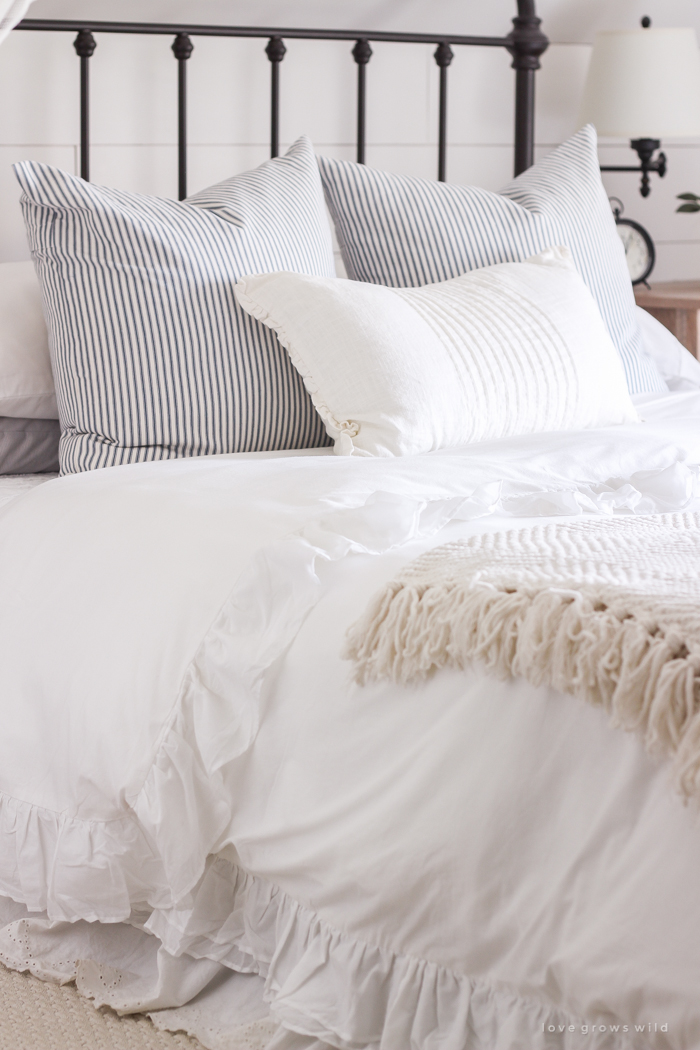 A clean and cozy farmhouse master bedroom with tons of vintage charm