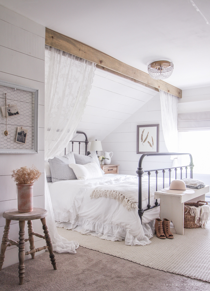 A clean and cozy farmhouse master bedroom with tons of vintage charm