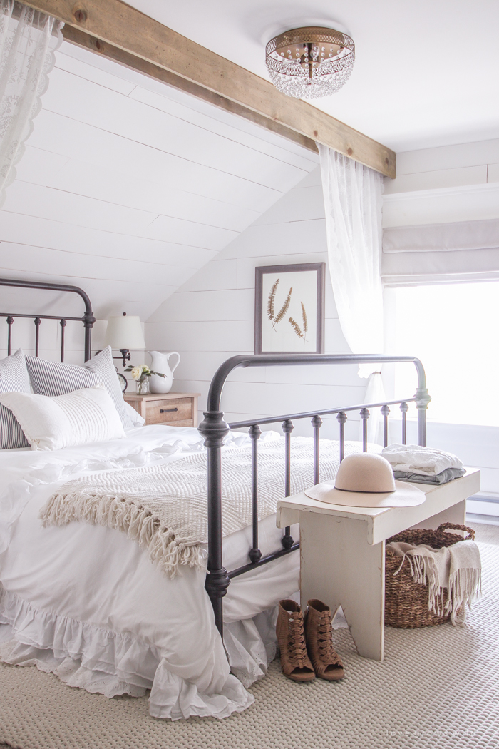 A clean and cozy farmhouse master bedroom with tons of vintage charm