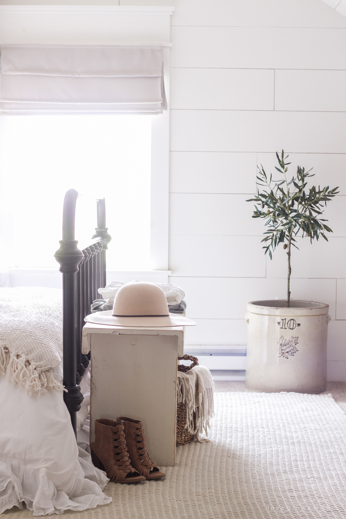 A clean and cozy farmhouse master bedroom with tons of vintage charm