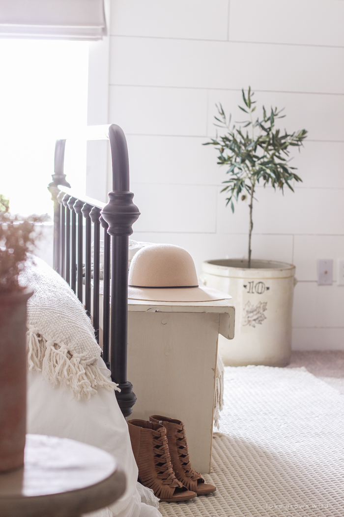 A clean and cozy farmhouse master bedroom with tons of vintage charm