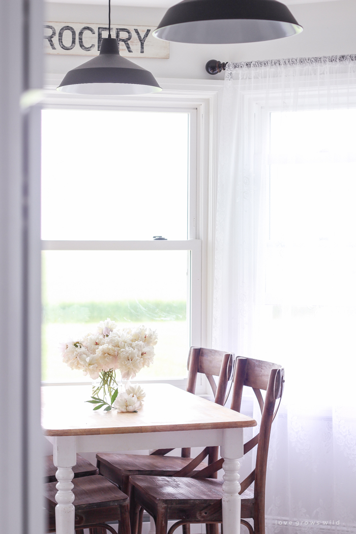 Freshly picked peonies decorate this beautiful farmhouse kitchen by Liz Fourez