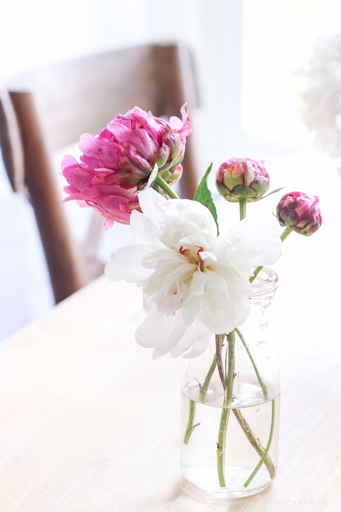 Freshly picked peonies decorate this beautiful farmhouse kitchen by Liz Fourez