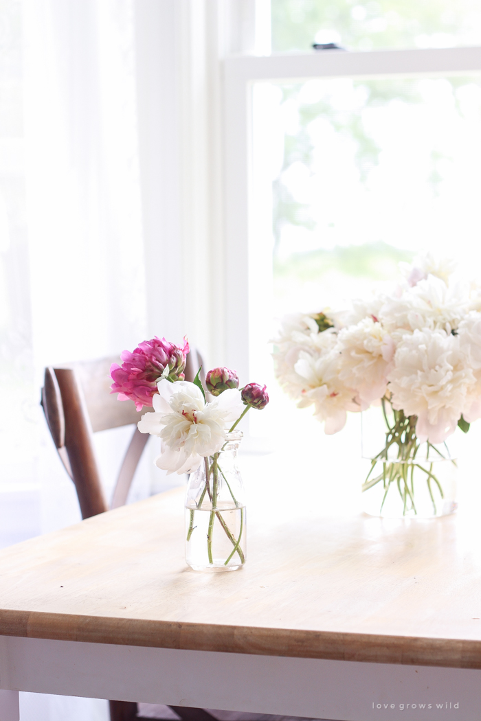 Freshly picked peonies decorate this beautiful farmhouse kitchen by Liz Fourez