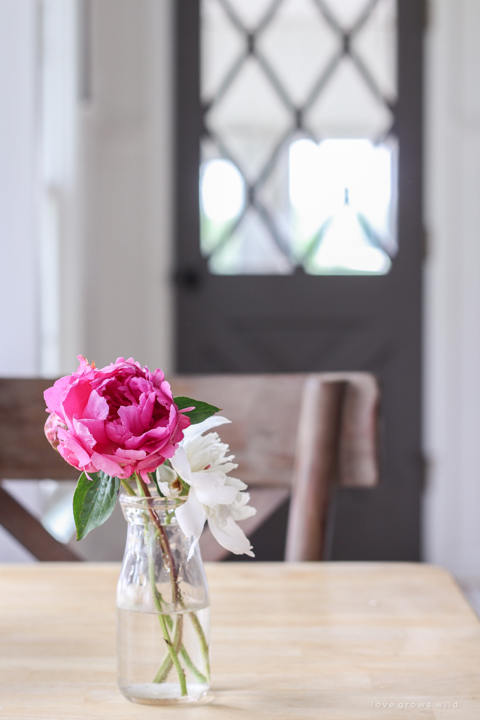 Freshly picked peonies decorate this beautiful farmhouse kitchen by Liz Fourez