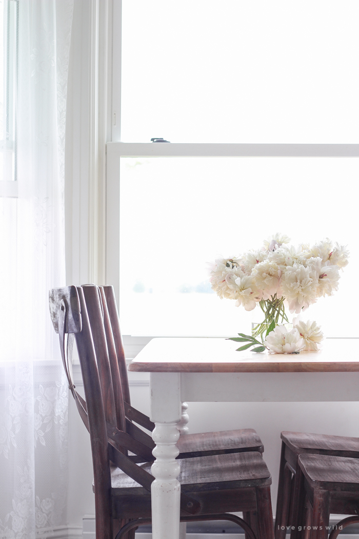 Freshly picked peonies decorate this beautiful farmhouse kitchen by Liz Fourez