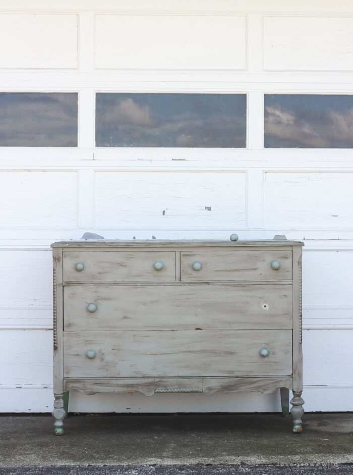 An old dresser gets a makeover with soft blue paint and a delicate hand painted design