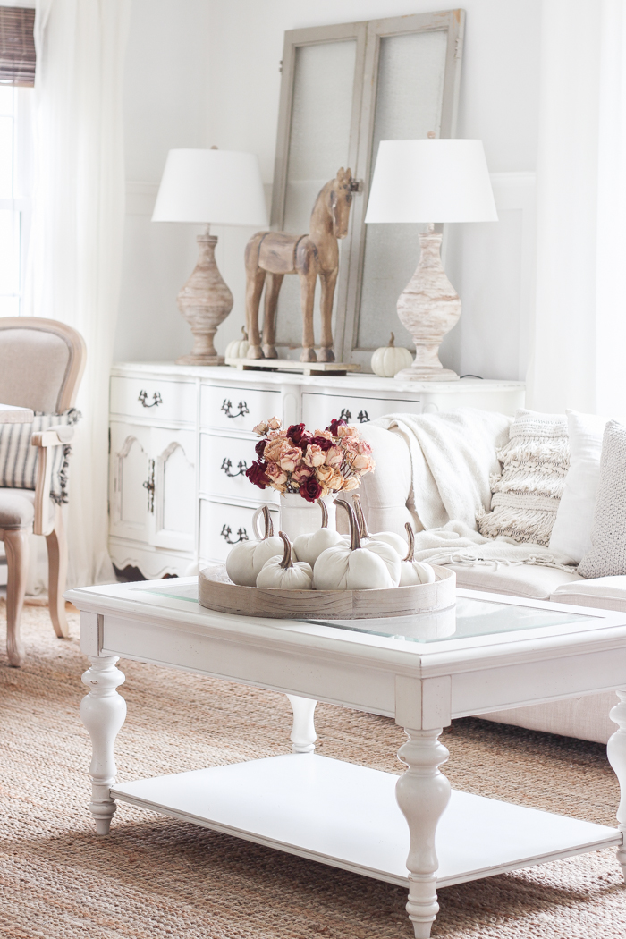 A beautiful farmhouse living room decorated with soft neutrals for fall