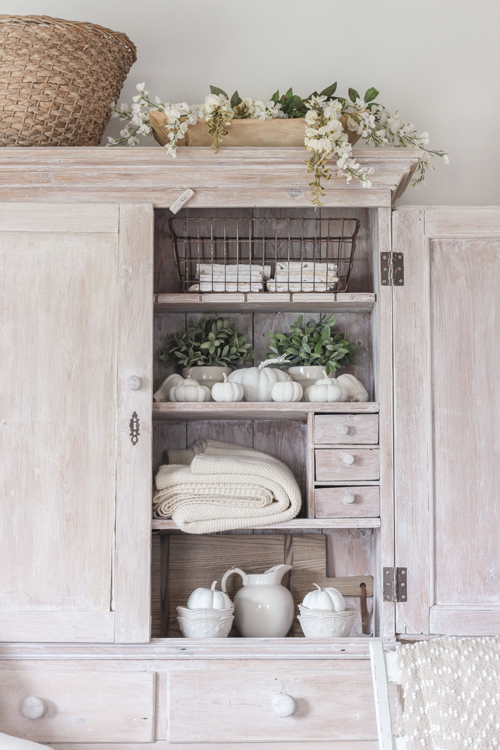 A beautiful farmhouse living room decorated with soft neutrals for fall