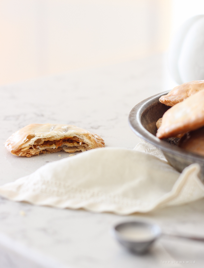 Maple Glazed Pumpkin Hand Pies - Adorable mini pies with cinnamon infused pumpkin filling wrapped in flaky pie crust and topped with a sweet maple glaze!