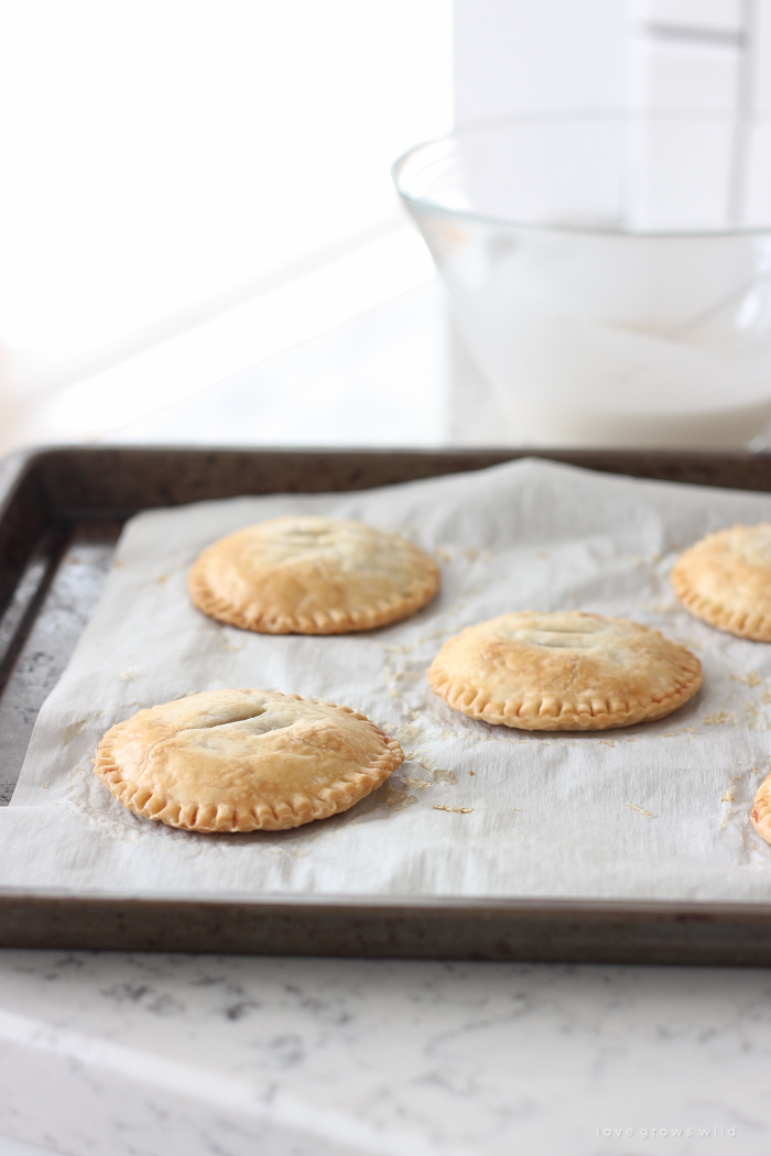 Maple Glazed Pumpkin Hand Pies - Adorable mini pies with cinnamon infused pumpkin filling wrapped in flaky pie crust and topped with a sweet maple glaze!