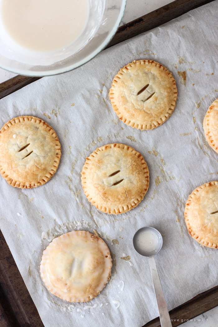 Maple Glazed Pumpkin Hand Pies - Adorable mini pies with cinnamon infused pumpkin filling wrapped in flaky pie crust and topped with a sweet maple glaze!