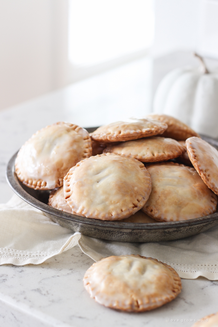 Maple Glazed Pumpkin Hand Pies - Adorable mini pies with cinnamon infused pumpkin filling wrapped in flaky pie crust and topped with a sweet maple glaze!