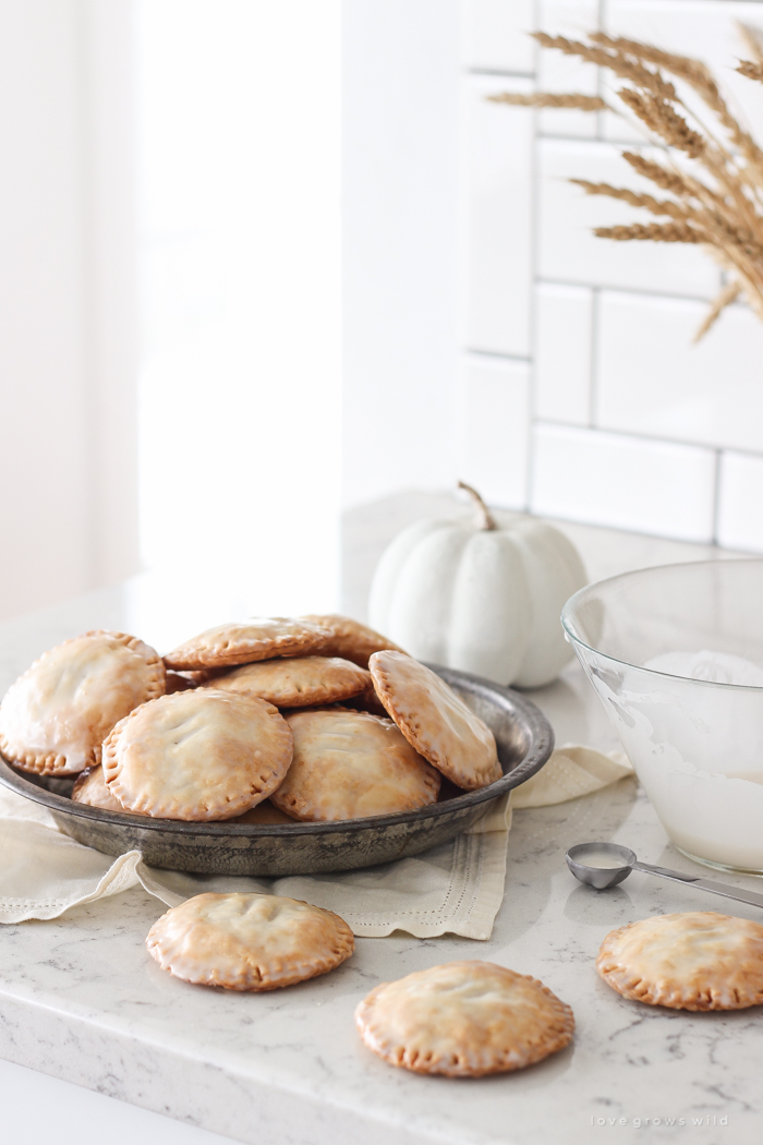 Maple Glazed Pumpkin Hand Pies - Adorable mini pies with cinnamon infused pumpkin filling wrapped in flaky pie crust and topped with a sweet maple glaze!