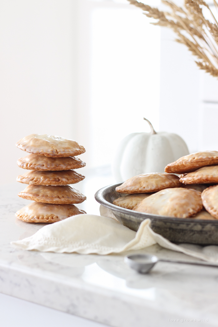 Maple Glazed Pumpkin Hand Pies - Adorable mini pies with cinnamon infused pumpkin filling wrapped in flaky pie crust and topped with a sweet maple glaze!