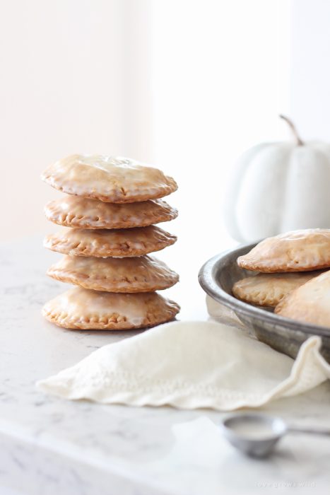 Maple Glazed Pumpkin Hand Pies - Adorable mini pies with cinnamon infused pumpkin filling wrapped in flaky pie crust and topped with a sweet maple glaze!