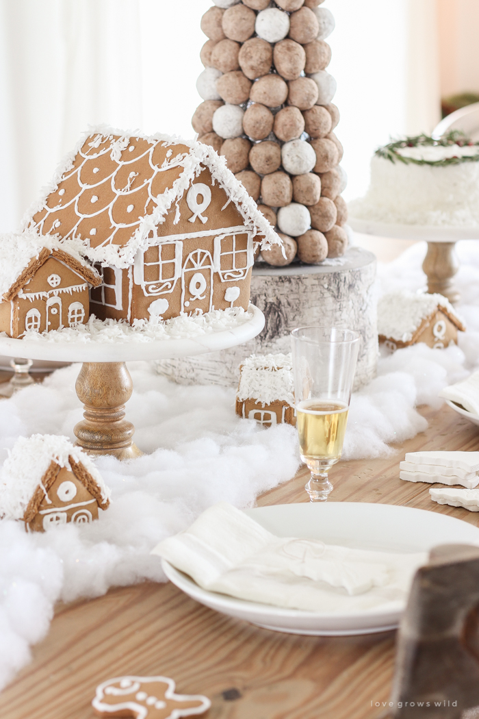 This adorable dessert table is perfect for the holidays and kids! Celebrate Christmas with gingerbread houses, a donut tree, festive cakes, cookies and more!