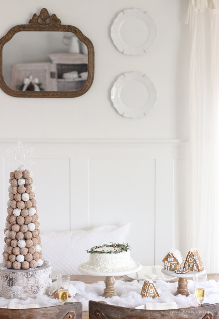 This adorable dessert table is perfect for the holidays and kids! Celebrate Christmas with gingerbread houses, a donut tree, festive cakes, cookies and more!