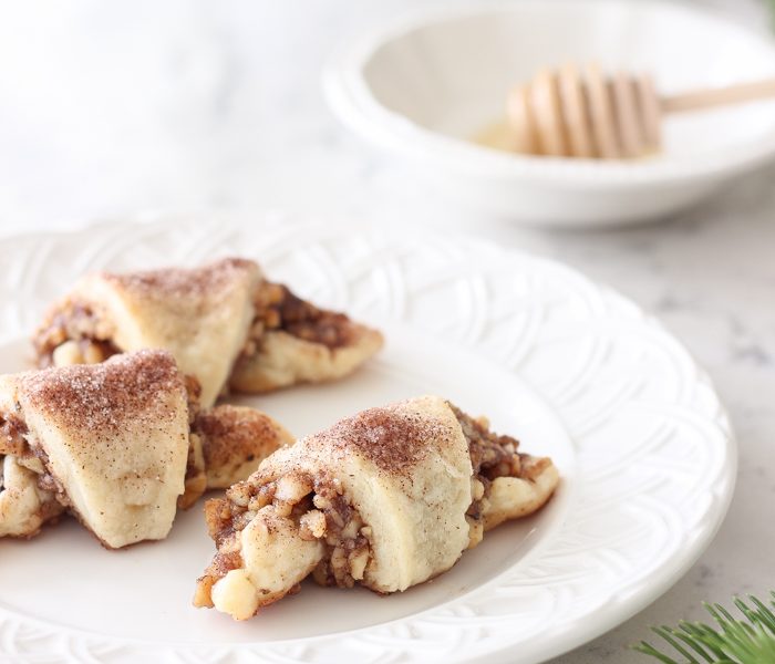 Tender, flaky pastries wrapped with a delicious honey nut filling and sprinkled with a hint of cinnamon sugar on top! These tasty treats are perfect for the holidays or any time of year!