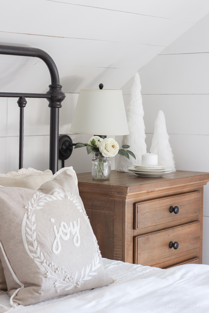 This cozy master bedroom is beautifully decorated for Christmas with soft neutrals and tons of farmhouse charm. 