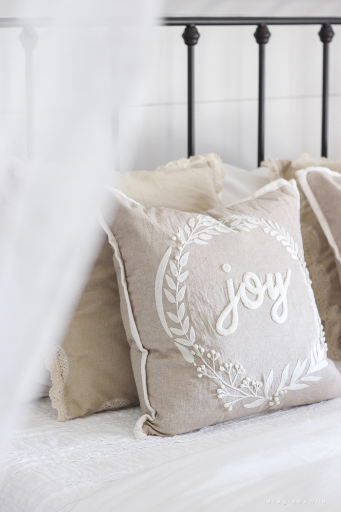 This cozy master bedroom is beautifully decorated for Christmas with soft neutrals and tons of farmhouse charm. 