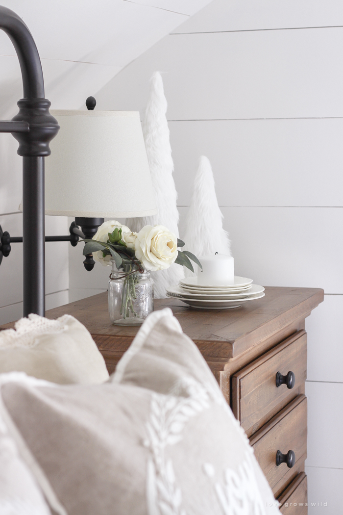 This cozy master bedroom is beautifully decorated for Christmas with soft neutrals and tons of farmhouse charm. 