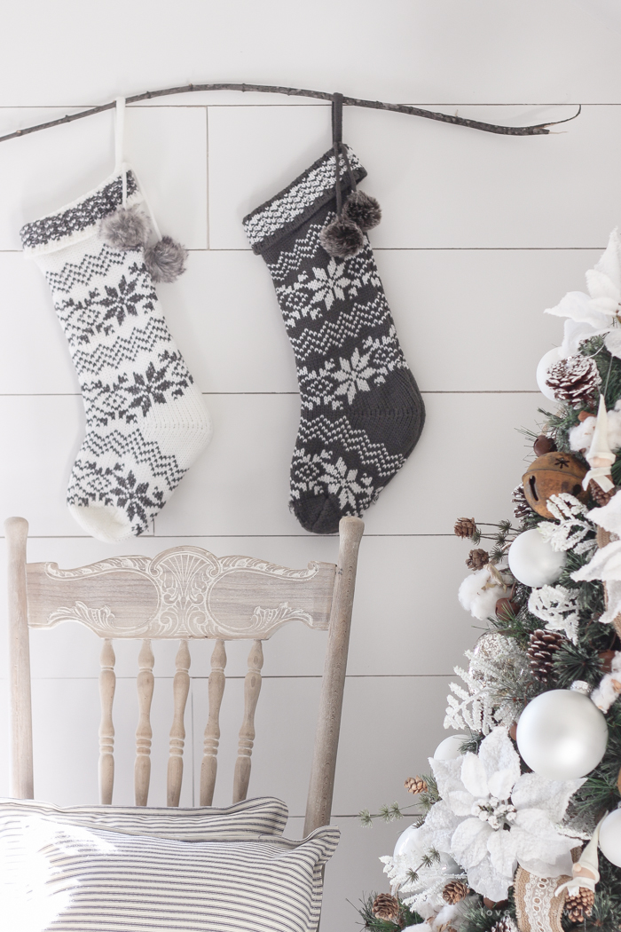 This cozy master bedroom is beautifully decorated for Christmas with soft neutrals and tons of farmhouse charm.