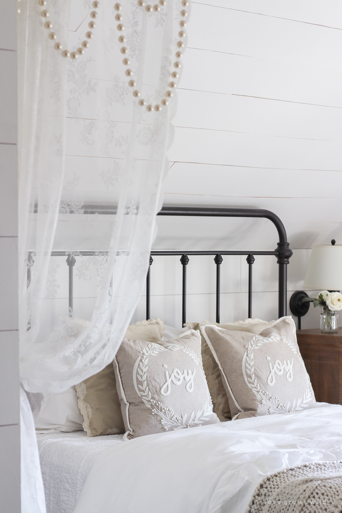 This cozy master bedroom is beautifully decorated for Christmas with soft neutrals and tons of farmhouse charm. 