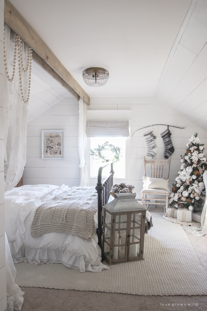 This cozy master bedroom is beautifully decorated for Christmas with soft neutrals and tons of farmhouse charm. 