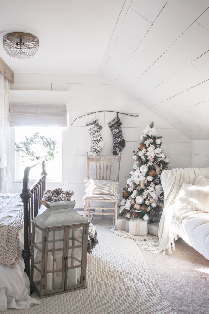 This cozy master bedroom is beautifully decorated for Christmas with soft neutrals and tons of farmhouse charm. 